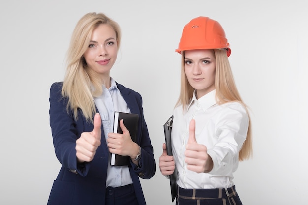 beautiful girls construction engineers show thumbs up