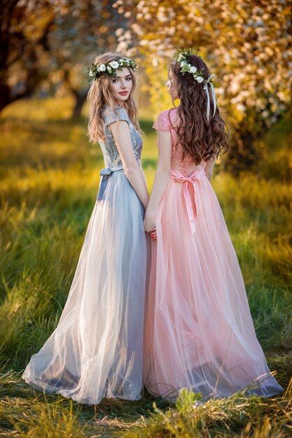 Beautiful girls in a flower spring garden