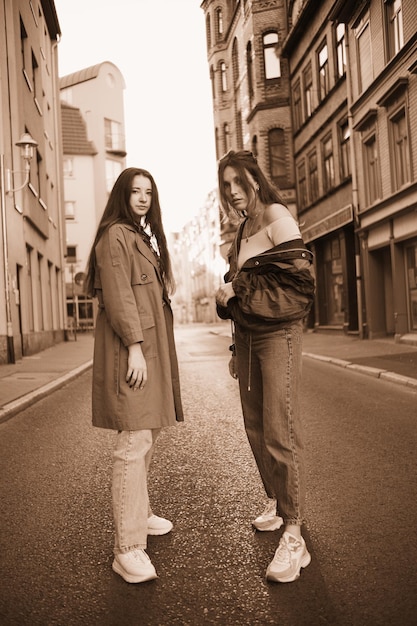 Beautiful girls posing on the street of a German town in the rays of the sunset