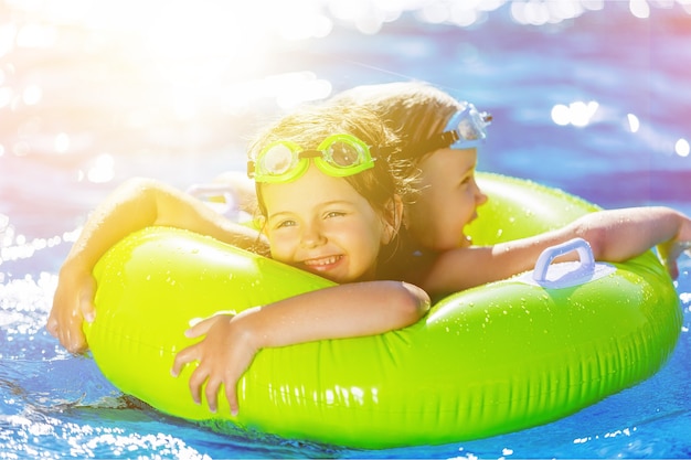 Beautiful girls at swimming pool in summer time