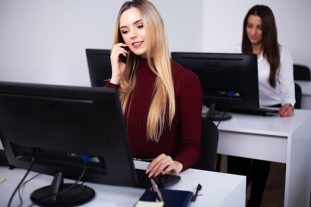 Beautiful girls working in the office of a consulting company