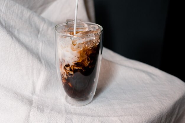 Beautiful glass of coffee with milk on the table