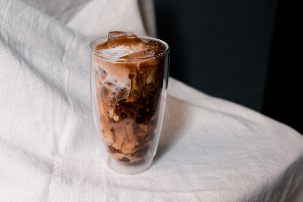 Beautiful glass of coffee with milk on the table