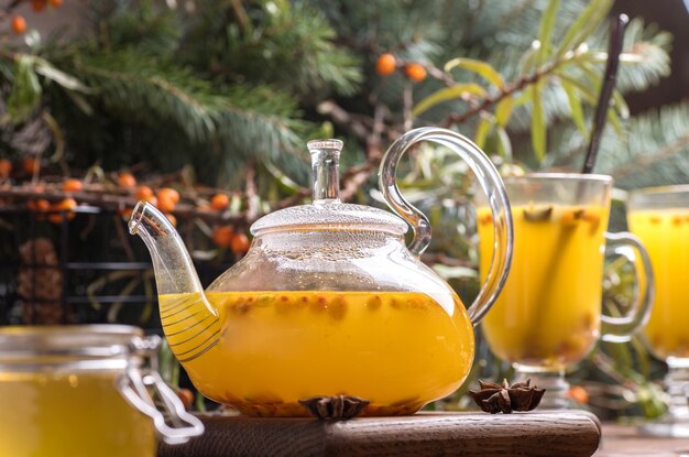 Beautiful glass teapot with sea buckthorn tea