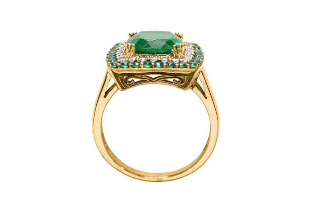 Beautiful gold ring with emeralds and diamonds isolated over white