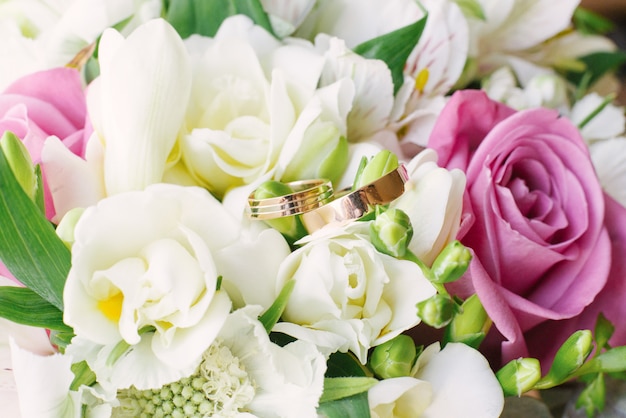 Beautiful gold wedding rings on a wedding bouquet