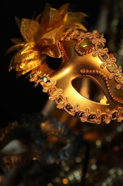 Beautiful golden carnival mask in darkness closeup