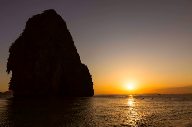 Beautiful golden sunset on the Phra Nang beach at Krabi in Thailand Cave mountain at the left