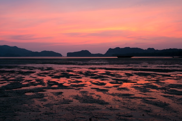 Beautiful golden sunset in the sea with saturated sky and clouds