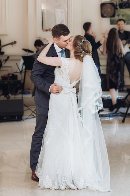 Beautiful gorgeous bride and groom performing first dance happy wedding couple dancing in restaurant at wedding reception happy marriage moments elopement concept