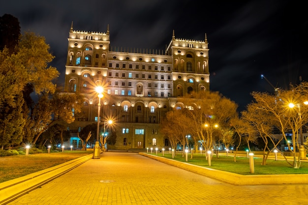 Beautiful Government House of Baku located in the middle of small garden at night