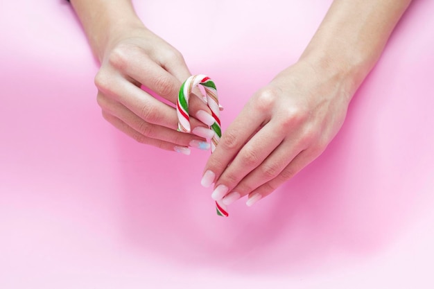 Beautiful gradient manicure. Christmas decorations in your hands. New Year's manicure concept