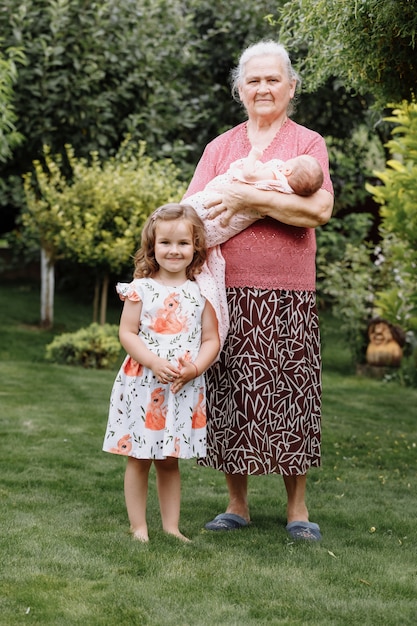 Beautiful grandmother Holding her One Newborn Cute baby Granddaughter