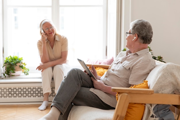 Beautiful grandparents couple learning to use digital device