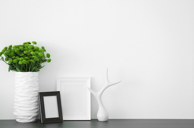 Beautiful green chrysanthemums in vase on commode in room