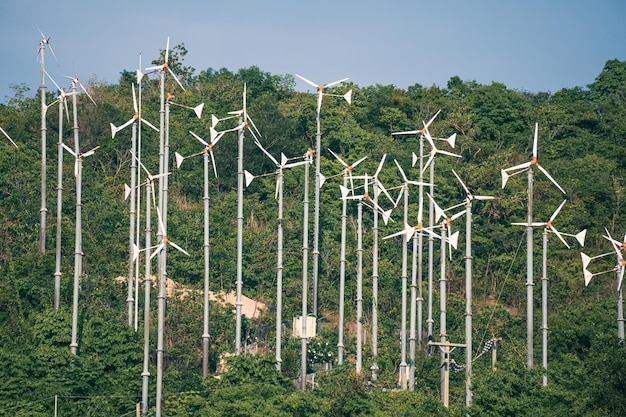 Beautiful green view of windmill farm providing ecofriendly energy sustainability wind power generator in jungle on island in Thailand Wind turbine Generation electricity from wind Lots windmills