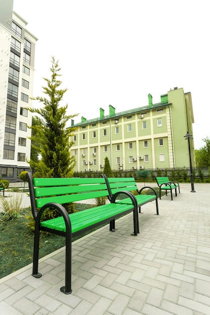 Beautiful green wooden bench in the courtyard of a new residential building