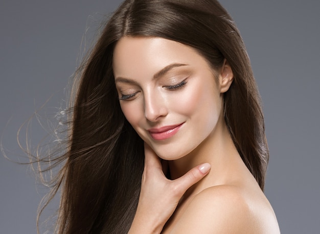 Beautiful hair woman long brunette hair beuty skin make up. Studio shot.