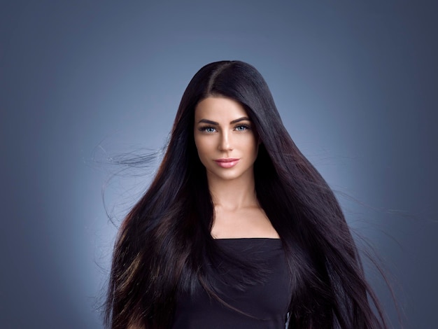 Beautiful hair woman with long brunette beauty helathy hairstyle female portrait. Studio shot.