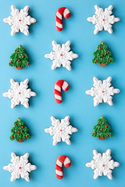 Beautiful handmade Christmas glazed gingerbread cookies on a blue background