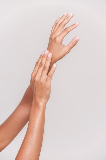 Beautiful hands. Close-up of beautiful female hands isolated on gray