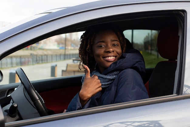 beautiful and happy African American in car