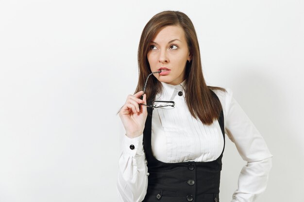 Beautiful happy caucasian young smiling brown-hair business woman in black suit, white shirt and glasses looking camera isolated on white wall