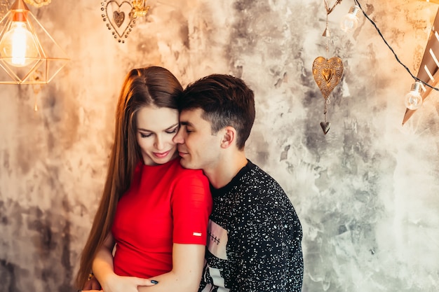 Beautiful happy couple at home in new year decor