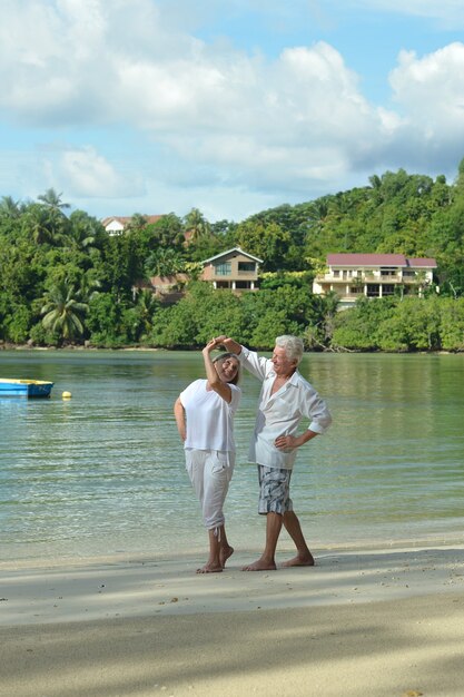 Beautiful happy elderly couple rest at tropical resort