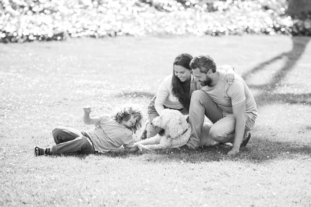 Beautiful happy family is having fun with dog outdoors cute family portrait the concept of a happy f...