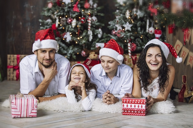 Beautiful happy family mother father son and daughter to celebrate Christmas together at home