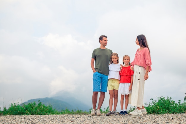 Beautiful happy family in mountains in the background of fog