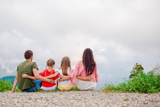 Beautiful happy family in mountains in the scene of fog