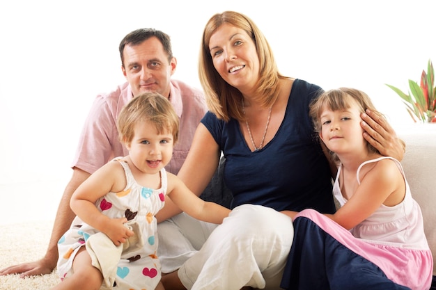 Beautiful happy family sitting on the floor