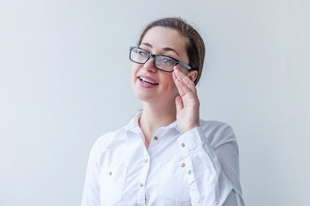 Beautiful happy girl smiling. Beauty simple portrait young smiling brunette woman in eyeglasses isolated on white background.