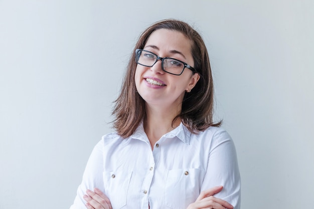 Beautiful happy girl smiling. Beauty simple portrait young smiling brunette woman in eyeglasses isolated