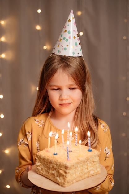 Beautiful happy girl with birthday cake