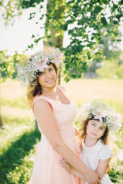 Beautiful happy mother with daughter smiling in the Park