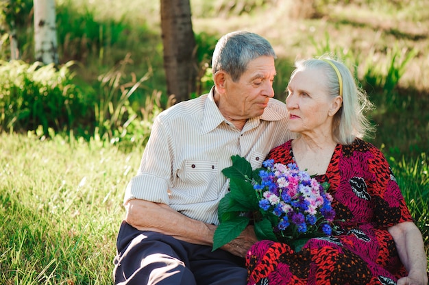 Beautiful happy old people sitting in the park.