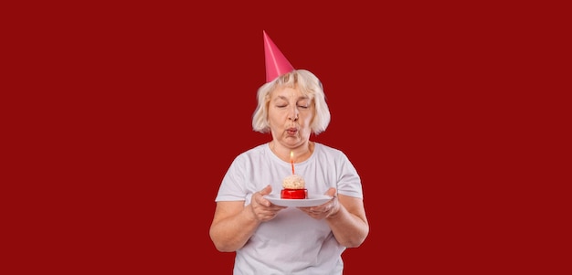 Beautiful happy senior woman wearing in a white tshirt standing