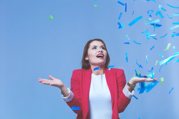 Beautiful happy woman at celebration party with confetti Birthday or New Year eve celebrating concept