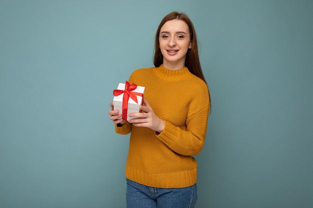 Beautiful happy young brunette woman isolated over colourful background wall wearing stylish casual clothes