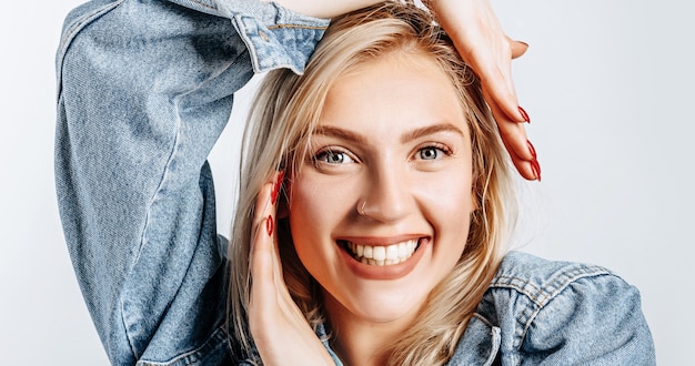 Beautiful happy young girl on gray isolated