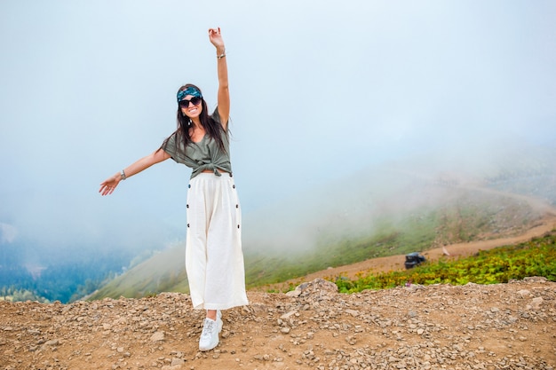 Beautiful happy young woman in mountains