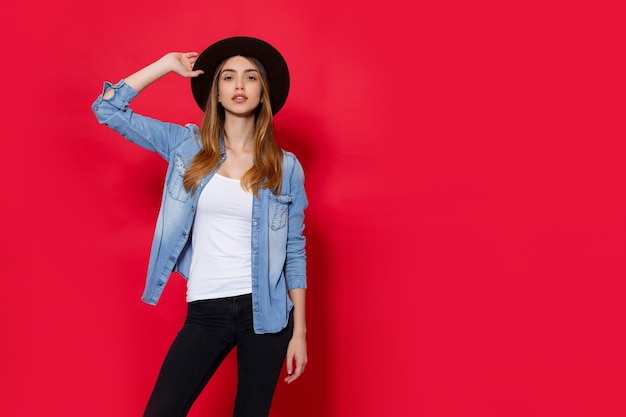 Beautiful happy young woman on a red background