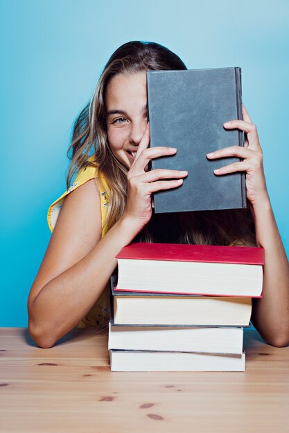 Beautiful happy young woman with books
