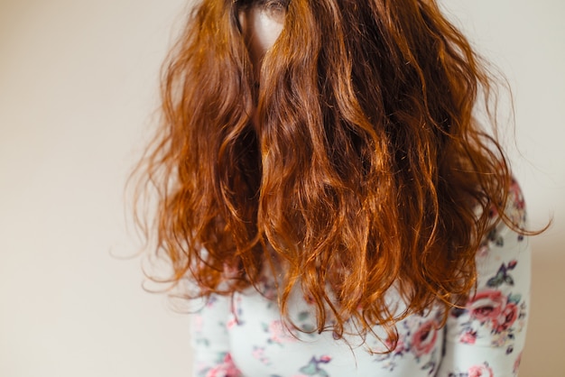 Beautiful, healthy, long, curly, red hair dyed with henna. Professional hair care.