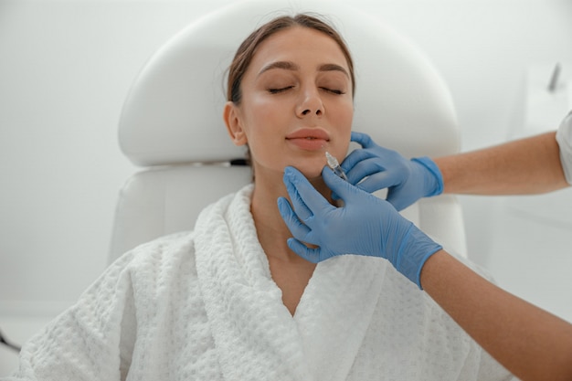 Beautiful healthy smiling caucasian woman is doing beauty procedures at spa and healthcare salon