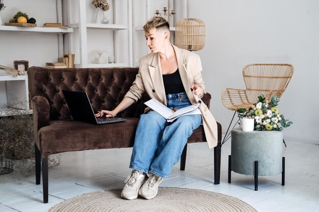 Beautiful hipster woman in casual cloth using laptop at home cheerful woman using laptop