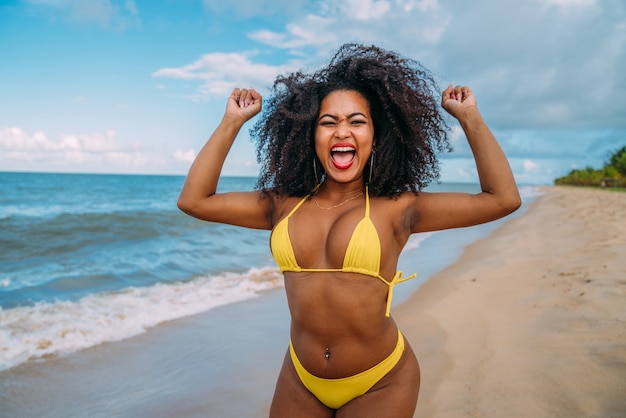 Beautiful hispanic woman in bikini on the beach